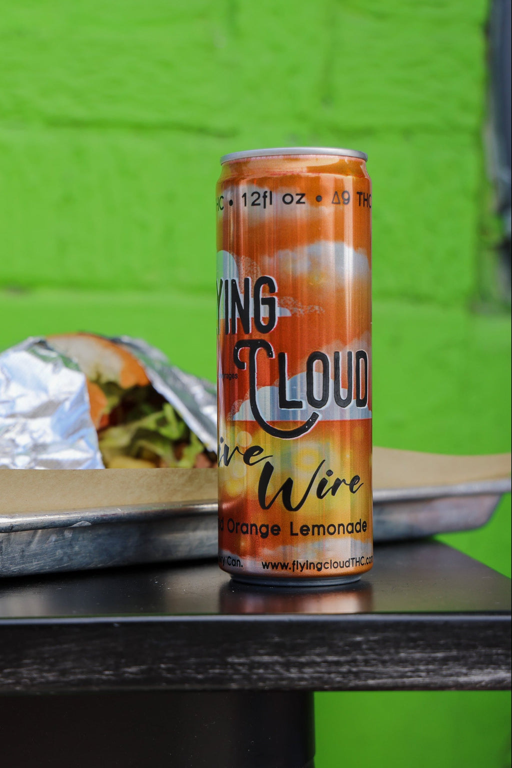 Can of Delta 9 THC drink on a table with a green background