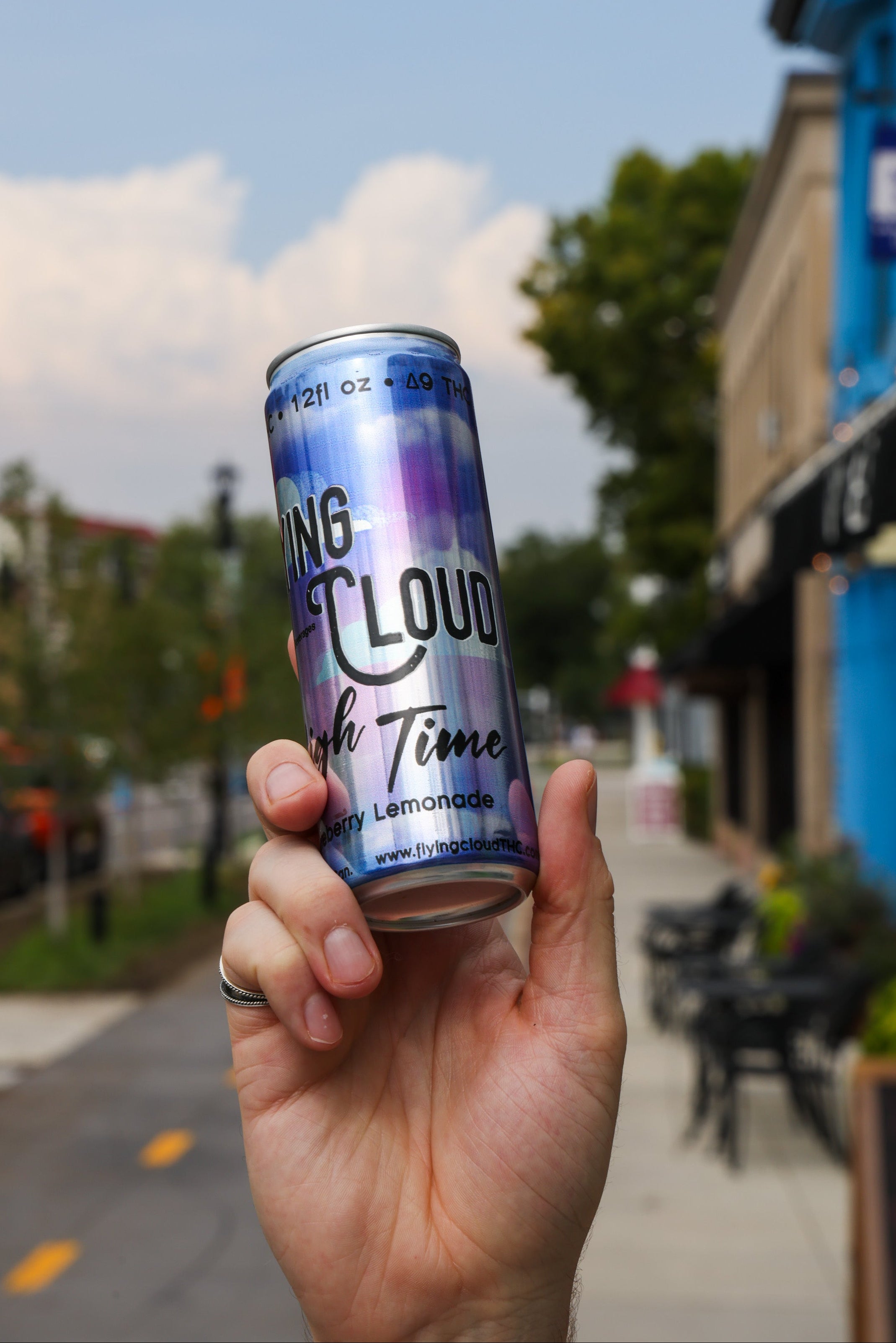 Can of Delta 9 THC drink on a table with a street background